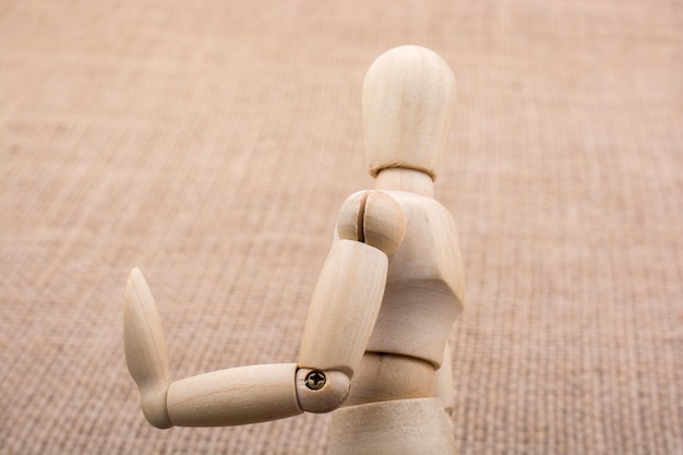 Wooden dolls posing on canvas