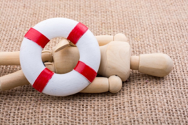 Wooden dolls posing with a life saver