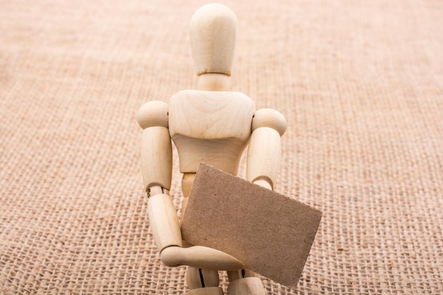 Wooden dolls posing with a noticeboard