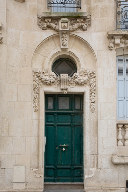 Wooden Door green classical on french wall city street classic facade