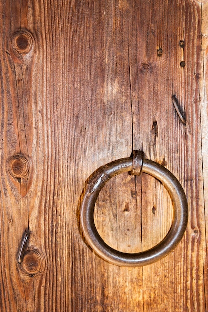 A wooden door with a ring