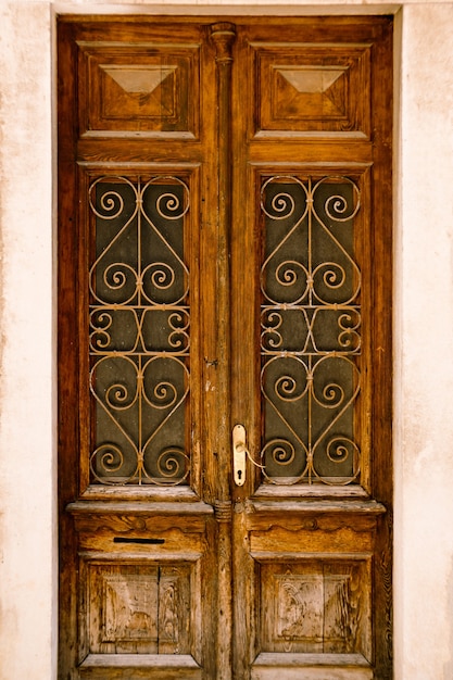 Wooden doors with metal glass bars and carved patterns