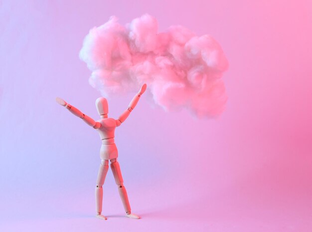 Wooden dreaming puppet and floating fluffy cloud in blue pink neon gradient light Creative idea Concept art Minimalism Surrealism