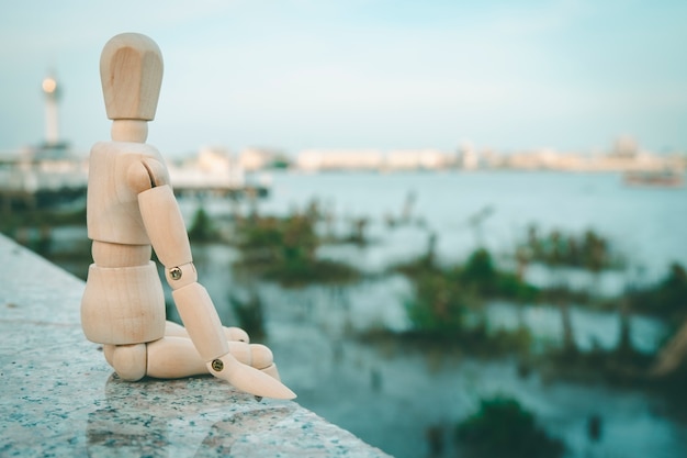 wooden dummy have feeling happiness on river view blur concept