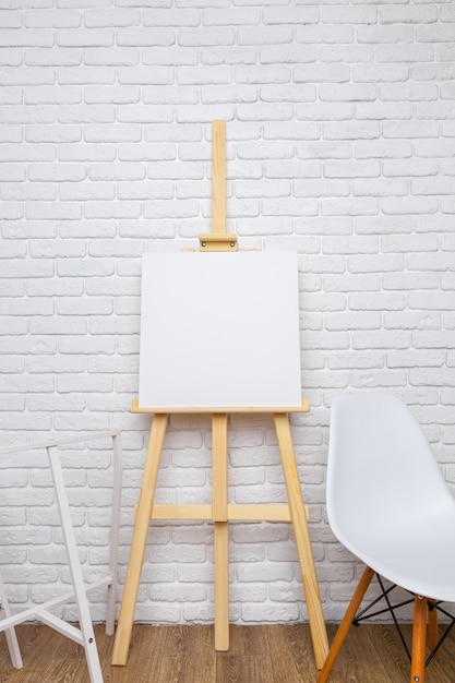 Wooden easel in the room