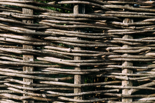 Wooden fence, assembled from flexible brown branches