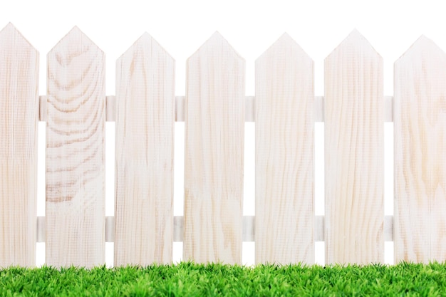 Wooden fence and green grass isolated on white