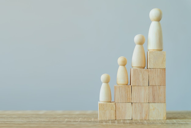 Wooden figures standing on wood stack