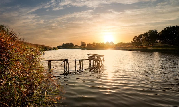 Wooden fishing sigean at sunset in autumn