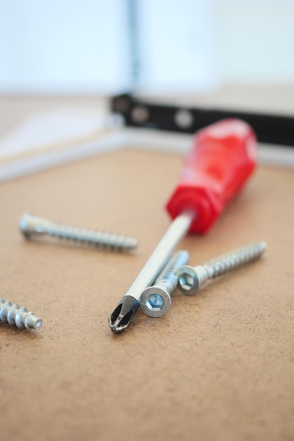 Wooden floor contains like screwdriver and nails in the drawer