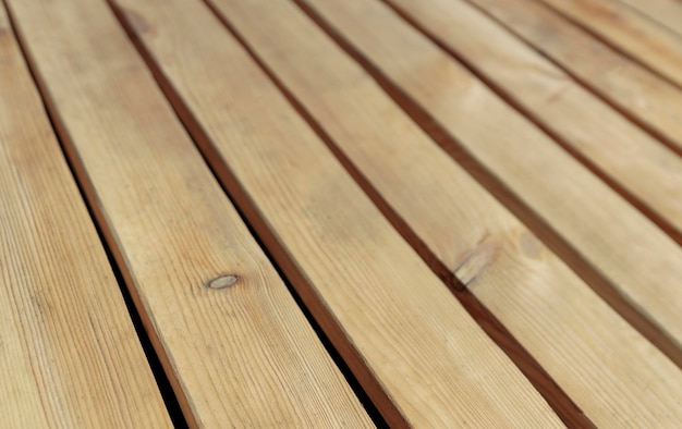 Wooden floor made of rough uncolored larch boards background photo with perspective effect