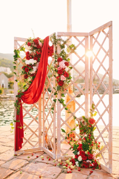 Wooden folding wedding screen stands on the cobbled pier