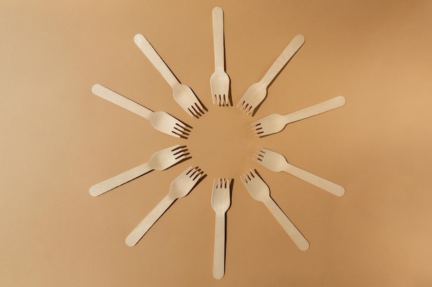 Wooden fork are laid out in circle Contrast lighting Eco friendly wooden cutlery Plastic Free