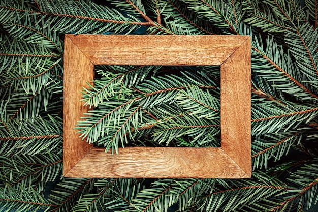 Wooden frame on Christmas tree branches Texture background