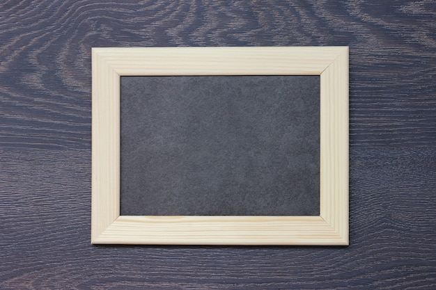 Wooden frame for photos on dark 