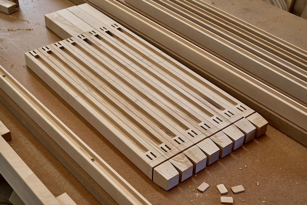 Wooden furniture legs folded on workbench in workshop Furniture details closeup