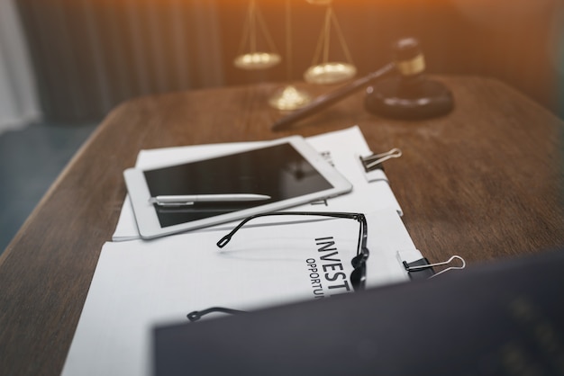 Wooden gavel and golden scales on courtroom, attorney and legal concept.