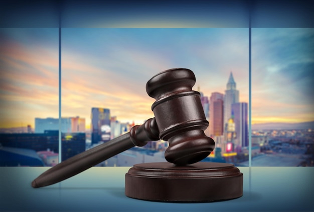 Wooden gavel on wooden table, on  background