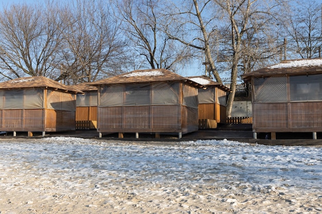 Wooden gazebos wrapped in foil in winter Insulation of gazebos in winter