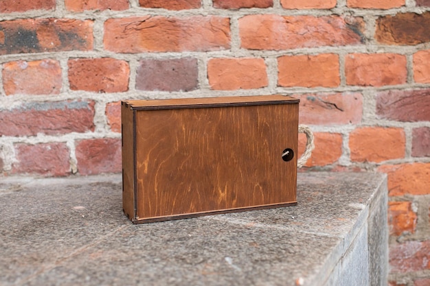 Wooden gift box on a brick wall background