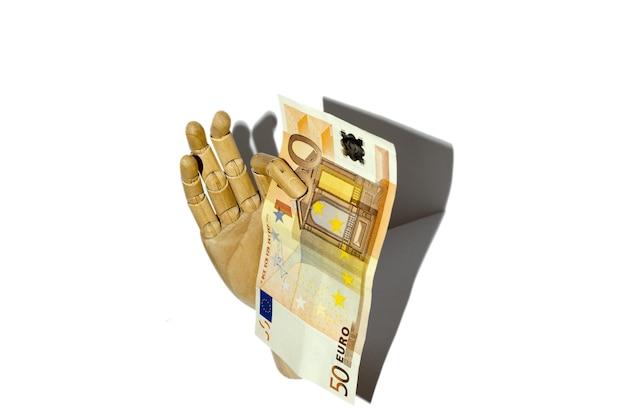 Wooden hand holding euro currency