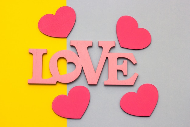 Wooden hearts on a multi-colored background, top view