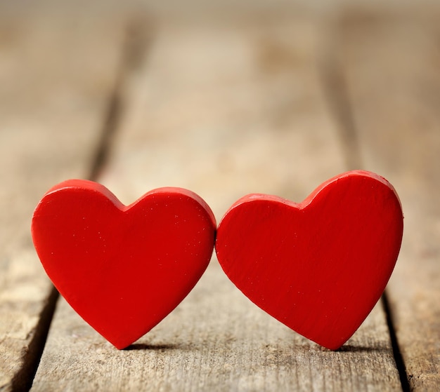 Wooden hearts on rustic wooden background