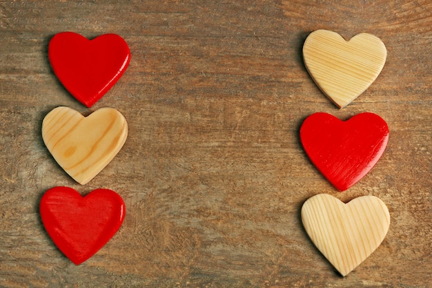 Wooden hearts on rustic wooden background