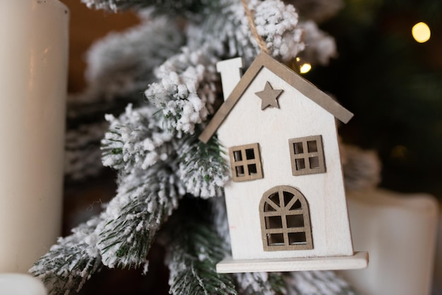 Wooden house Christmas toy on the Christmas tree