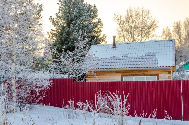 wooden house in the forest on a winter day.