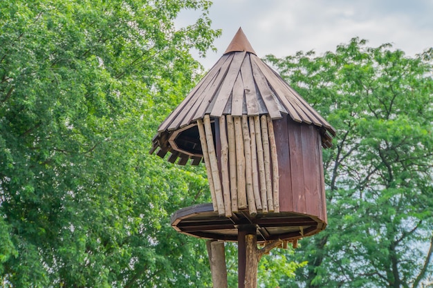 A wooden house for small birds that adorn home garden