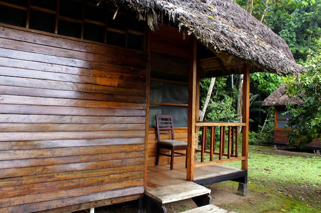 A wooden house with a thatched roof