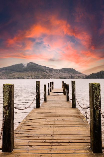 A wooden jetty on a lake at sunset Landscape