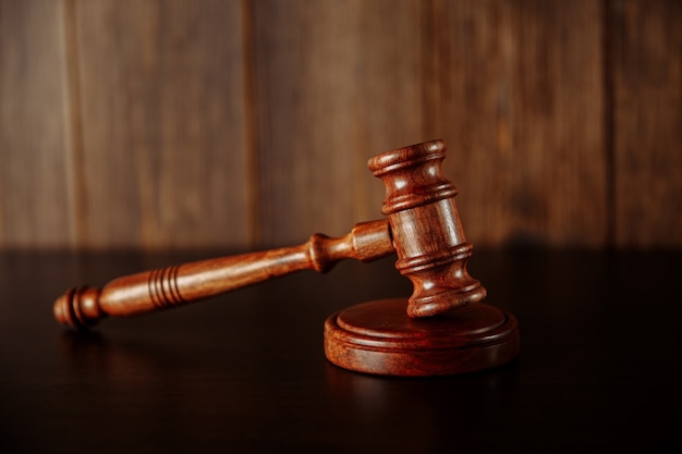 Wooden judge's hammer on wooden table