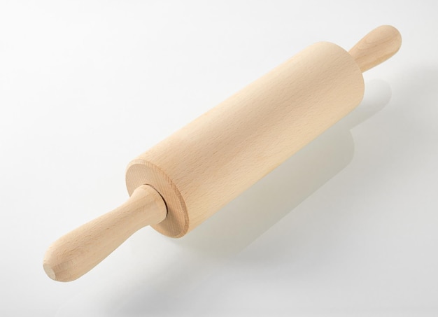 Wooden kitchen utensils the rolling pin for dough is reflected in the glass surface