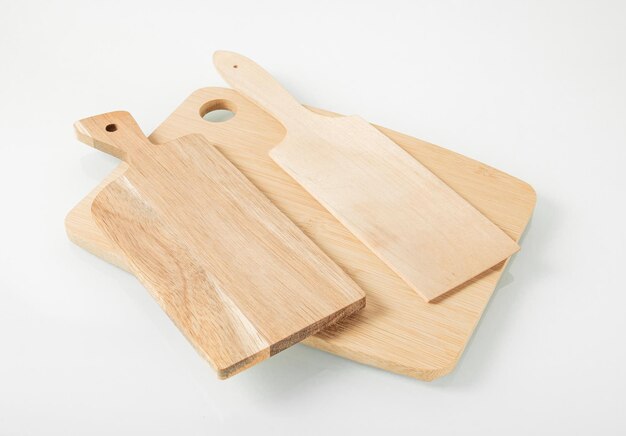 Wooden kitchen utensilsThree cutting boards on a light background