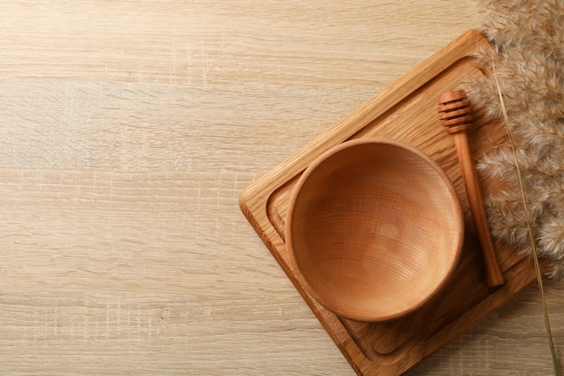 Wooden kitchenware and reed on wooden table