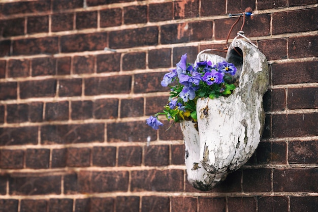 Wooden klompen on brick wall background