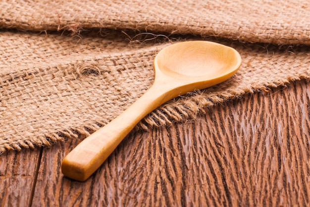 wooden ladle on sackcloth close up