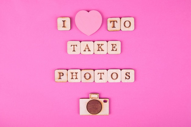 Wooden letters, inscription on a bright pink background. International Day of Photography