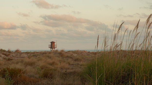 Wooden lifeguard post on a lonely beach at dusk