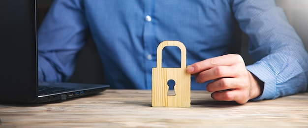 Wooden lock with man working on computer