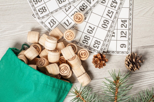 Wooden lotto barrels with bag and game cards for a game in lotto