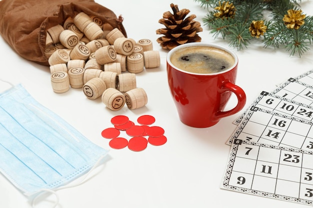 Wooden lotto barrels with bag game cards red chips and cup of coffee