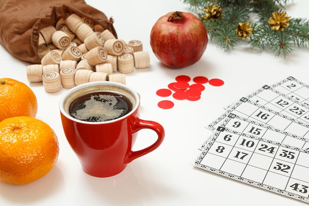 Wooden lotto barrels with bag game cards red chips and cup of coffee