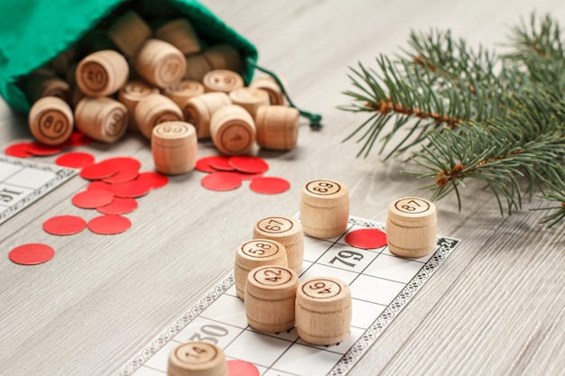 Wooden lotto barrels with bag game cards and red chips for a game in lotto