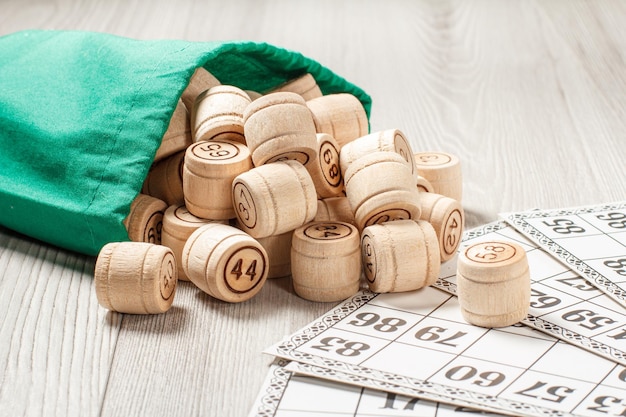 Wooden lotto barrels with green bag and game cards for a game