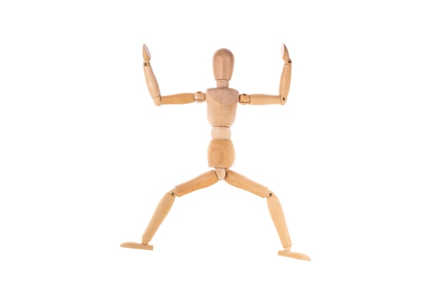 Wooden man in a jump spread his arms isolated on a white background Stretch concept High quality photo