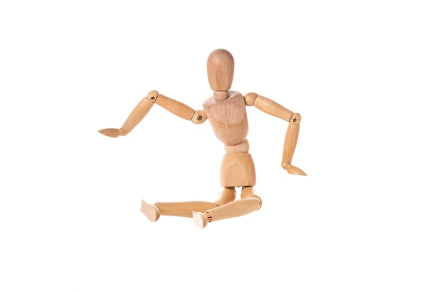 Wooden man in a jump spread his arms isolated on a white background Stretch concept High quality photo