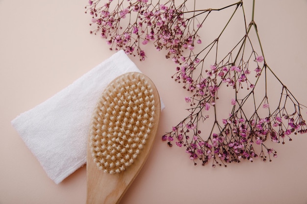 Wooden massage brush with natural bristles and towel for spa Healthy and firm skin concept